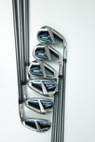 Five golf iron clubs arranged in descending size order on a clean white background, featuring a polished silver metal finish with black and blue accents on the clubheads.