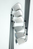 A set of six golf iron clubs arranged in a fan pattern on a clean white background, showing their polished silver metal heads and dark shafts.