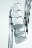 A set of five polished silver golf irons arranged diagonally on a clean white background.