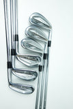 A set of eight golf iron clubs arranged diagonally on a clean white background, showcasing their polished silver metal heads and black grip accents.