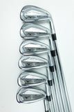 Six Mizuno golf iron clubs arranged in a row on a clean white background, showing their polished silver metal heads and black shaft bands.