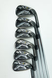 Six TaylorMade Axiom golf iron clubs arranged in a diagonal row on a clean white background.